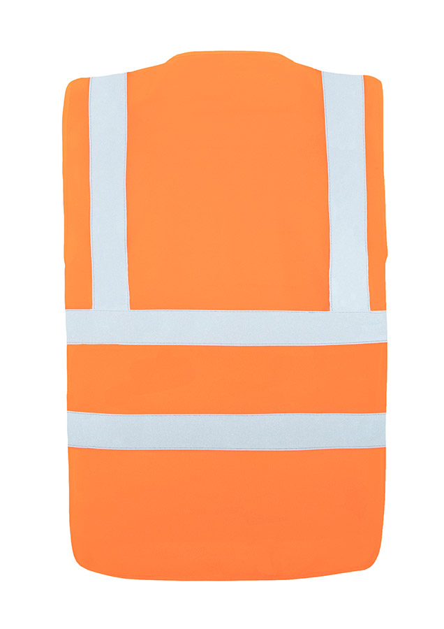 Adult in orange Korntex safety vest with four reflective stripes standing in an industrial environment
